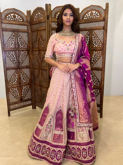 A classic pose showing the full outfit, including the detailed border of the lehenga.