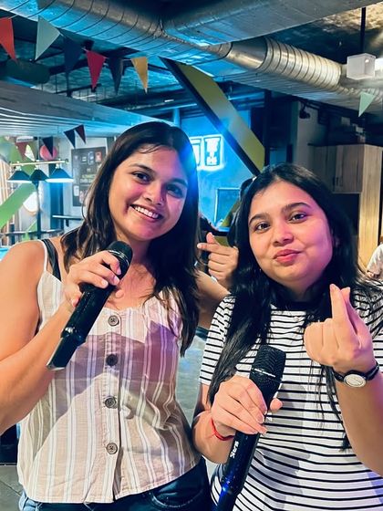 Celebrating Holi with a riot of melodies. Friends take the mic together, singing their hearts out in multiple languages to match the festival's vibrant spirit.