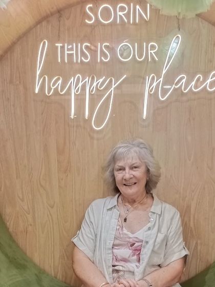 A happy client radiating calm and contentment after her services. This serene smile is what we strive for with every guest.