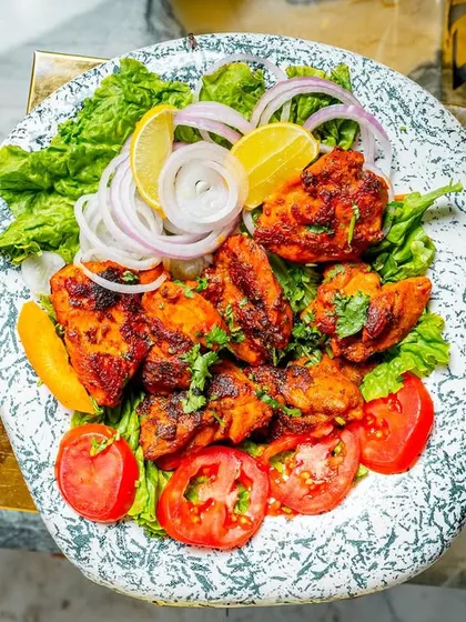 Fresh out of the tandoor, my sumptuous chicken tikka is marinated in traditional spices and grilled until tender and juicy. It's a classic dish that never fails to impress.
