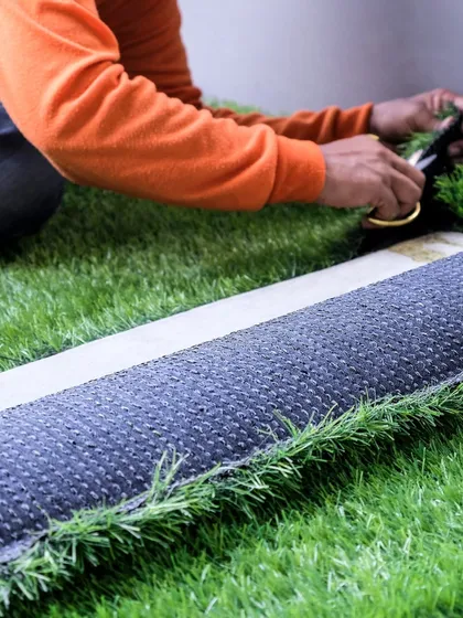 Here you can see the precision involved in my installation process. I carefully measure and cut each piece of turf to ensure a perfect fit and seamless joints, resulting in a flawless, professional finish for every project.