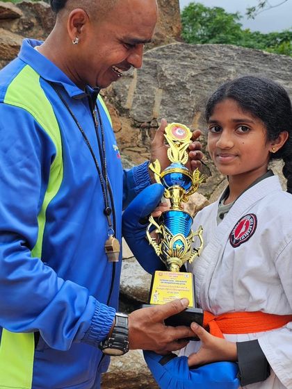 Presenting a trophy to one of my dedicated female students. Her focus and hard work paid off, and it is an honor to celebrate her victory.