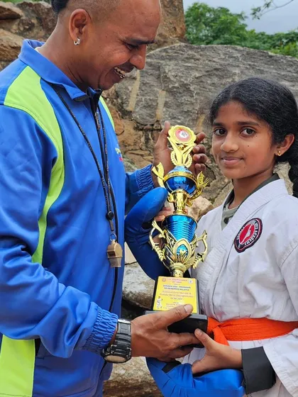 A happy student receives her trophy. We encourage our girls to be strong and fearless competitors in the sport of karate.