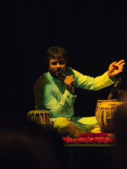Here I am addressing the audience during a mesmerizing night of ghazals at the Courtyard Baithak. It's important to me to connect with the listeners and share the story of the music we are creating.