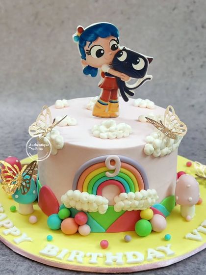 A colorful and sweet True and the Rainbow Kingdom cake. This design features True and her cat Bartleby, surrounded by clouds, butterflies, and a bright rainbow.