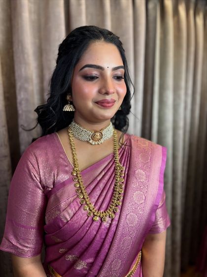 The final engagement look, with soft makeup and a beautiful pink saree.
