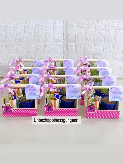 A display of the 12th birthday return gifts, showing the consistent pink polka-dot theme across the entire order.
