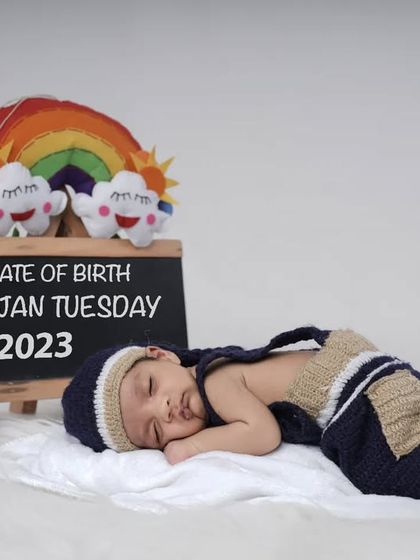 A personalized way to announce your baby's arrival. This setup includes a chalkboard with the baby's birth details, creating a unique and memorable keepsake photo.