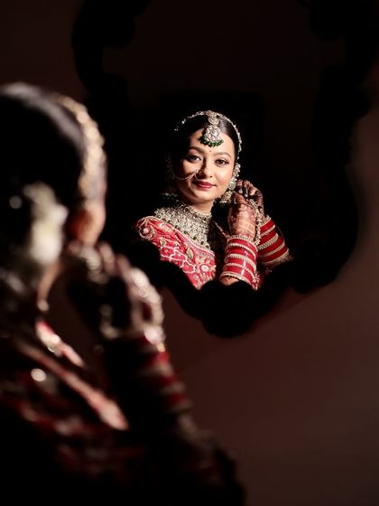 A creative reflection shot. Krupa's look in the mirror is a perfect example of how we balance traditional elements with a modern, soft glam aesthetic.