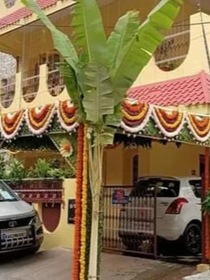 A simple yet beautiful 'Chappra' for a home ceremony. This entrance arch, decorated with marigold garlands and banana saplings, maintains a traditional and auspicious feel for the wedding house.