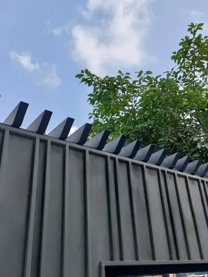 The top detail of the minimalist boundary wall, featuring angled coping elements. This small but important detail adds a sharp, geometric finish to the wall, protecting it from the elements while contributing to the overall modern aesthetic.