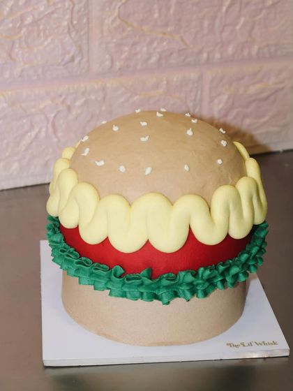 Lettuce celebrate with a cake that looks just like a burger. We had so much fun sculpting the bun, patty, and toppings entirely out of buttercream for a truly unique birthday surprise.