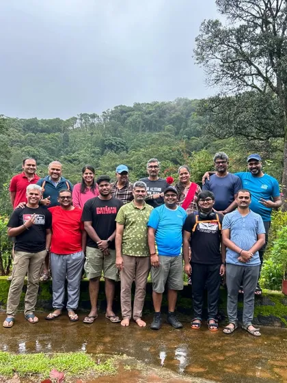 A group photo from a corporate outing, with everyone looking refreshed and happy after a day in nature.