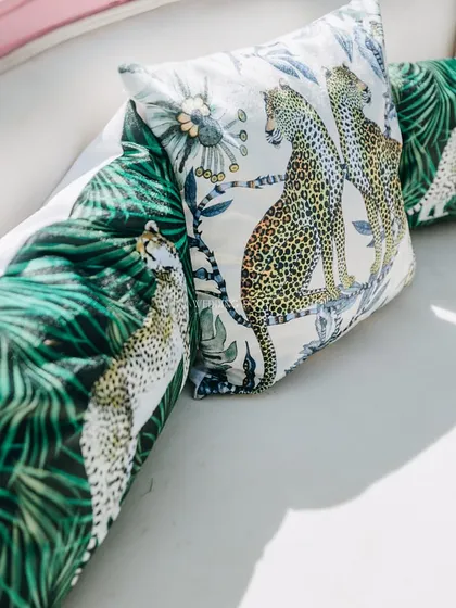 Custom-printed cushions featuring a jungle and leopard motif. These small details helped to cohesively carry the "wild" theme throughout the event space.