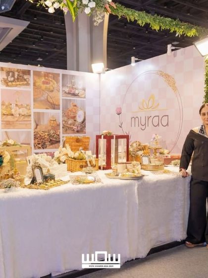 A full view of my beautiful exhibition stall at the WOW Awards, decorated with a floral arch and a lush green vine.