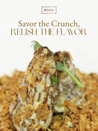 Every bite of this dish is a symphony of crunch and flavour. Here, crispy elements are layered with a creamy sauce and fresh herbs, creating a multi-sensory experience.