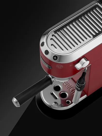 A reminder to power through the week. This De'Longhi coffee machine is a piece of art. I shot it from a high angle to showcase the cup heater on top, a key feature, and to highlight its glossy red finish and chrome details.