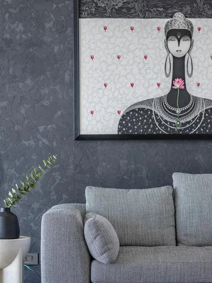 Art is central to our design storytelling. This striking piece adds a personal and emotive touch to the living room, contrasting beautifully against the dark, textured wall.