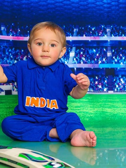 This little cricketer is ready to play for Team India. It's a fun way to include family passions into a child's photoshoot.