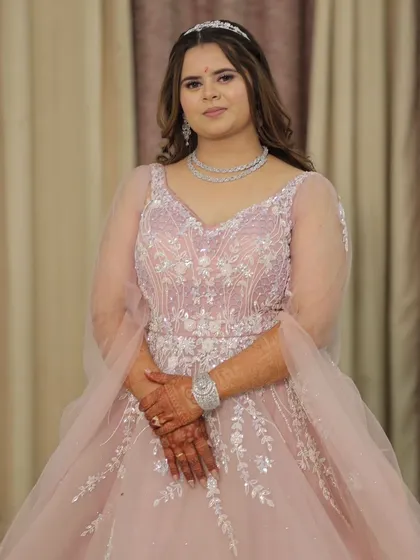 A close-up of the bodice on the pastel pink gown. You can see the intricate beadwork and embroidery that gives this dress its elegant and high-quality finish.