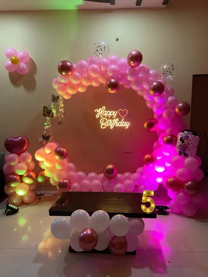 An elegant pink and rose gold 5th birthday decoration, perfect for an indoor home party.