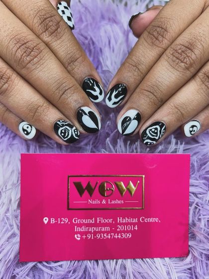 A striking black and white abstract design. This look on short, oval nails is perfect for those who love graphic, high-contrast art.
