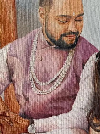 A detail shot of the groom's expression and the intricate henna on the bride's hand.
