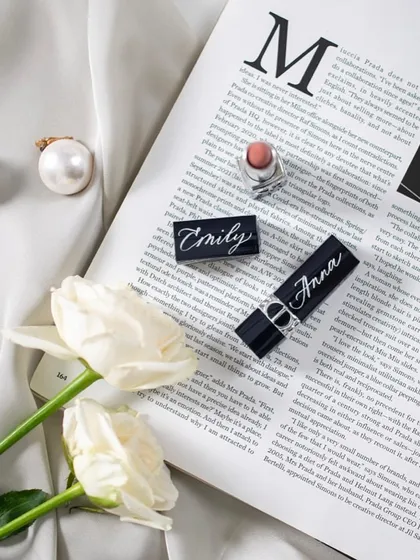 Details matter. This flat lay shows personalized Dior lipsticks, turning an everyday luxury into a bespoke treasure.
