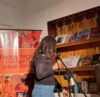 A young singer making her debut on our stage. I am always overjoyed to provide a platform for new talent to step into the spotlight and share their passion.