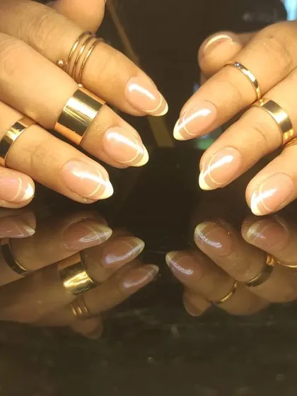A classic French manicure on almond-shaped nails, showcasing a clean and timeless look perfect for any occasion.