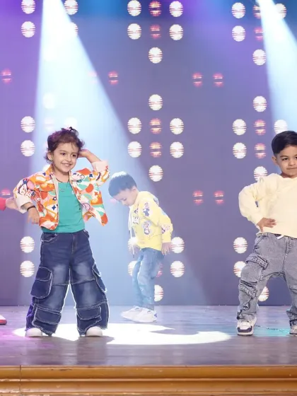 Our toddlers showing off their moves at the 'WSS-25' showcase. Dressed in cool, casual outfits, they perform a hip hop routine, demonstrating their rhythm and stage presence.