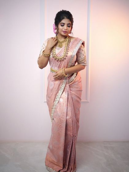 This model showcases a complete bridal look with our layered gold harams and matching waist belt. The jewellery is designed to complement the soft elegance of a pastel silk saree.