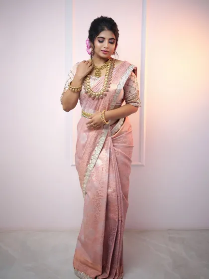 A model in a soft pink saree adorned with our complete temple jewellery set, including a kasu malai, showcasing a classic and elegant bridal look.