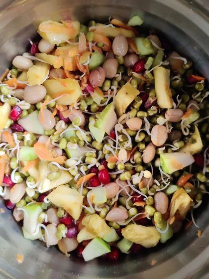 This vibrant salad is packed with fiber and protein. It features sprouted moong, beans, fresh vegetables, and fruits. It's a perfect example of a filling, nutrient-dense meal that supports weight loss and gut health.