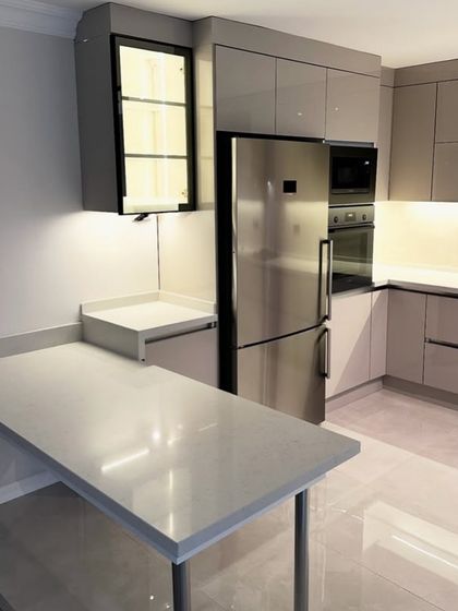 This angle shows the practical breakfast counter extension in the DLF Suncity kitchen project. It's a perfect example of how we create multi-functional spaces, combining cooking areas with casual dining.