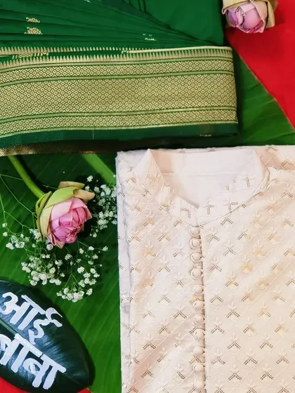 The complete look for the parents-to-be. Here is the pre-pleated green saree alongside the matching men's kurta, ready for a special baby shower celebration.