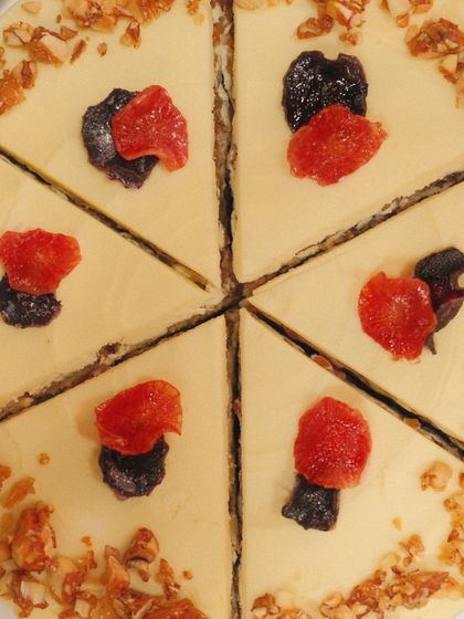 An overhead shot of our Dilli Carrot Cake, sliced and ready to be served. The dried fruits on top add a lovely touch of colour and flavour.