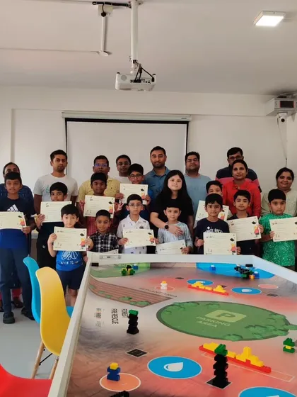 A group photo of our students, parents, and instructors at the certificate distribution ceremony, celebrating a successful term together.