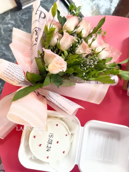 A sweet and simple combo featuring a minimalist bento cake with a special date and a lovely bouquet of pink roses.