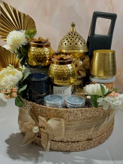 Our Glitterati gift hamper is designed for those who love a bit of sparkle. This golden basket is filled with brass decor, premium snacks, and optional wine.