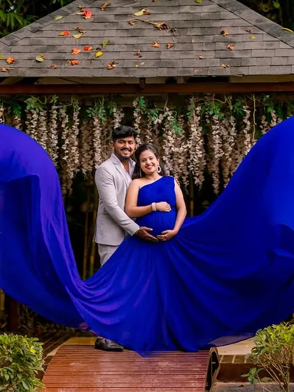 The power and beauty of motherhood are on full display in this shot. I use dramatic, flowing gowns like this vibrant blue one to create stunning, artistic maternity portraits. This was taken at a garden location with a beautiful wooden gazebo in the background.