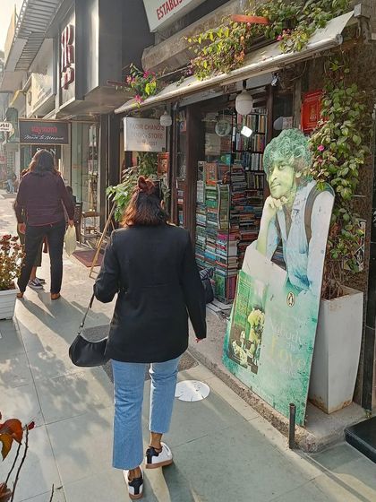A candid moment of me walking towards a bookstore, part of my yearly tradition of buying a new book to start the year. This shares a personal ritual with my audience.