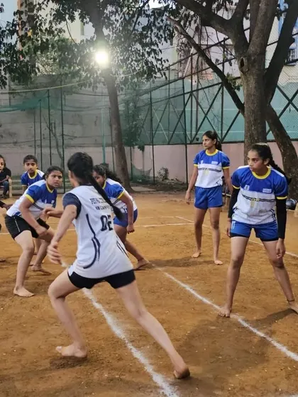 A raider from the opposing team carefully approaches our girls' defensive line during a practice match.