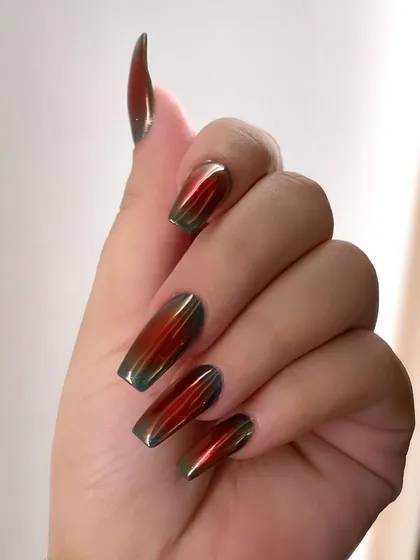 This multi-chrome look is for the bold and daring. The color shifts from a fiery red to a deep green, creating a mesmerizing, oil-slick effect on long coffin nails.