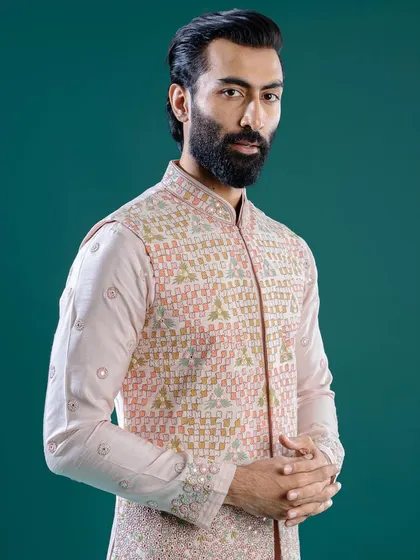 A pastel pink ensemble featuring a Jawahar jacket with geometric embroidery. This ethereal silhouette is an ideal choice for a Pooja ceremony or daytime event during the Navratri season.