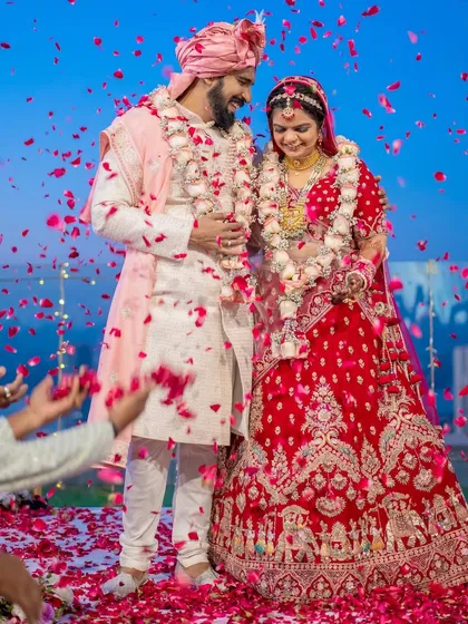 The climax of the ceremony, a shower of petals celebrating the union. We focus on capturing the energy and emotion of such peak moments, with the couple surrounded by the joy of their loved ones.