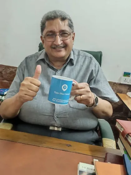 A senior and respected client showing his appreciation with our gift mug. We are honored to serve customers of all ages.