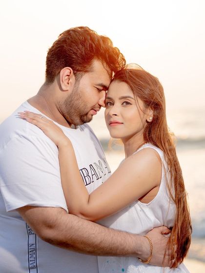 An intimate embrace on the beach, this pre-wedding portrait focuses on the couple's connection and the beautiful golden hour light.