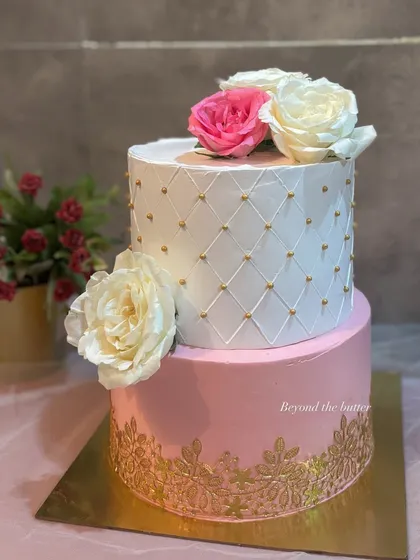 I believe every wedding deserves a stunning cake. This two-tier beauty features a classic white quilted design with gold pearls, a delicate gold lace pattern on the pink bottom tier, and is finished with beautiful fresh roses. It’s a timeless choice for a Nikkah or engagement.