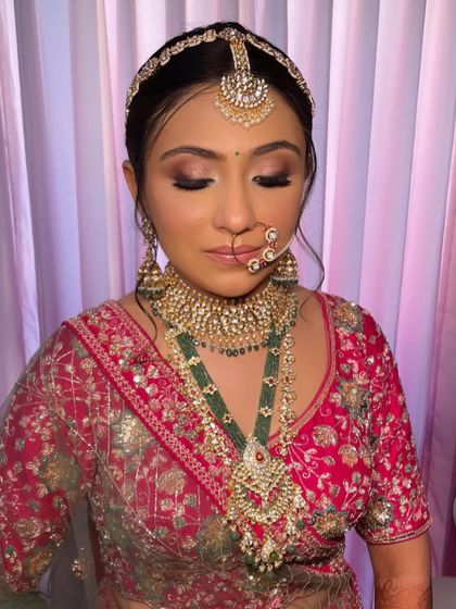 A close-up of the bride's stunning makeup and her elegant, traditional hairstyle.
